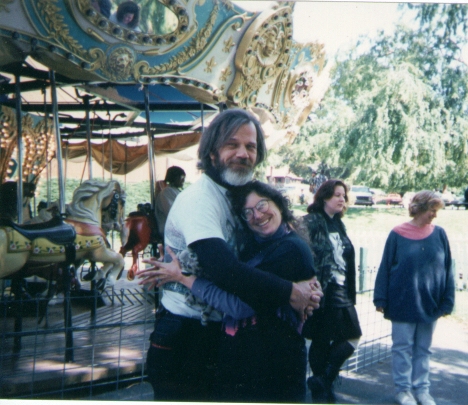 Wolf and Mou hugging by the carousel