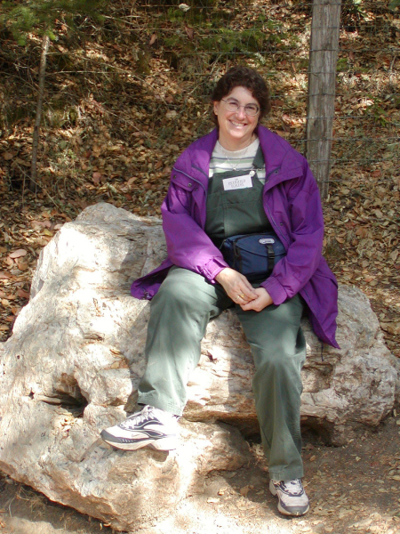 Martha sitting on a petrified log